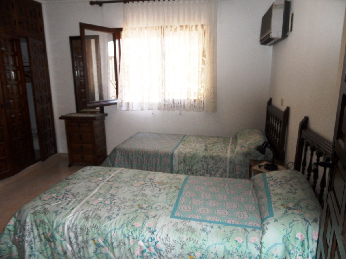 A bedroom with two beds.